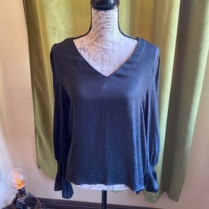 This is a v-neck snake skin print long sleeved blouse in size Medium.